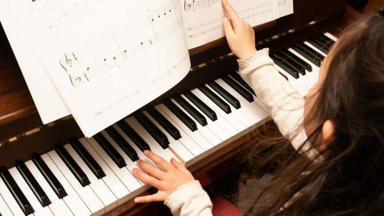 girl playing piano close up
